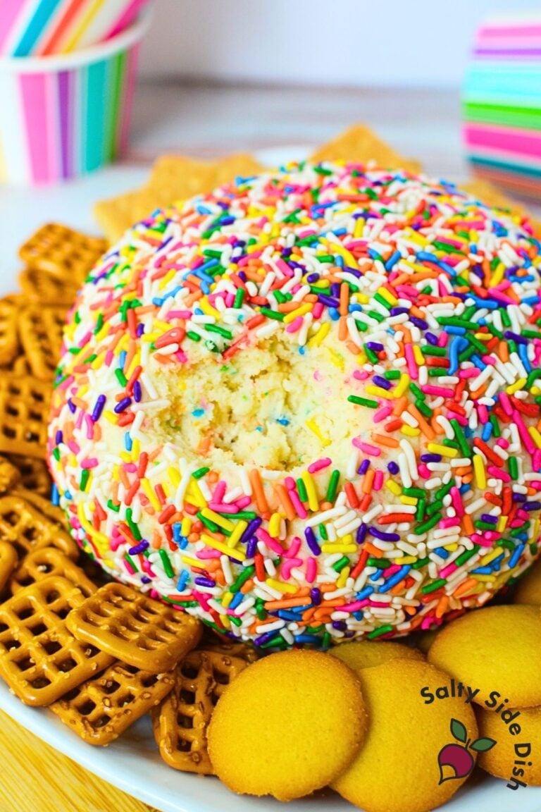 Funfetti dessert cheese ball rolled in colorful sprinkles with graham crackers and pretzels for dipping.