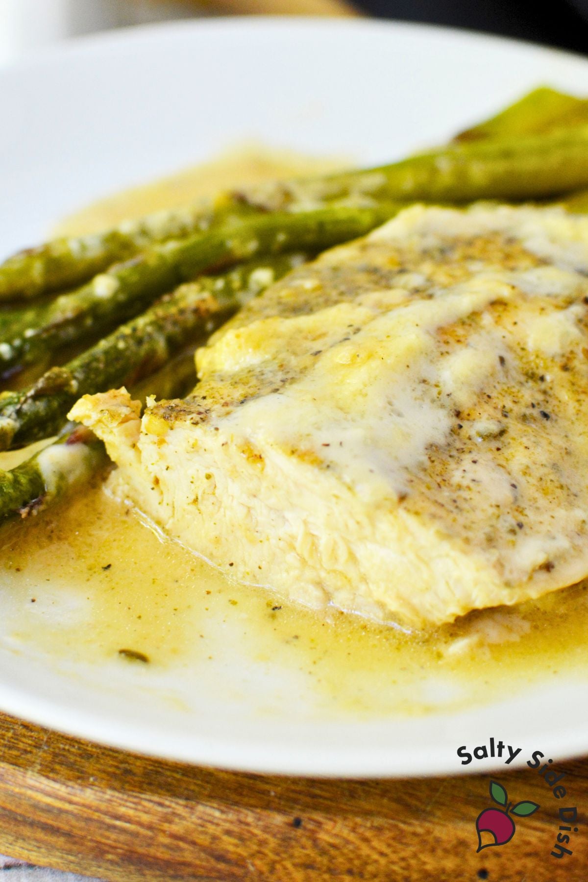 Cast iron Caesar chicken skillet recipe featuring golden baked chicken and asparagus