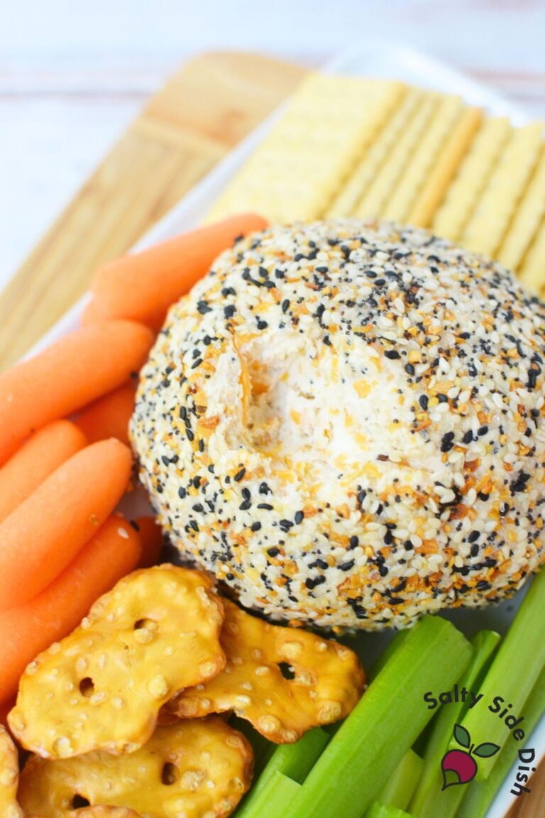 Everything bagel cheese ball appetizer with carrots, celery sticks, and crackers