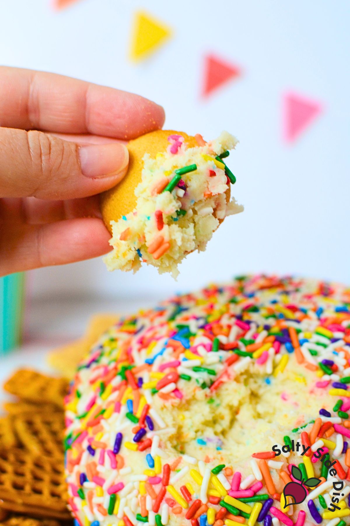 Creamy funfetti cream cheese ball with sprinkles, served as a no bake birthday dessert dip.