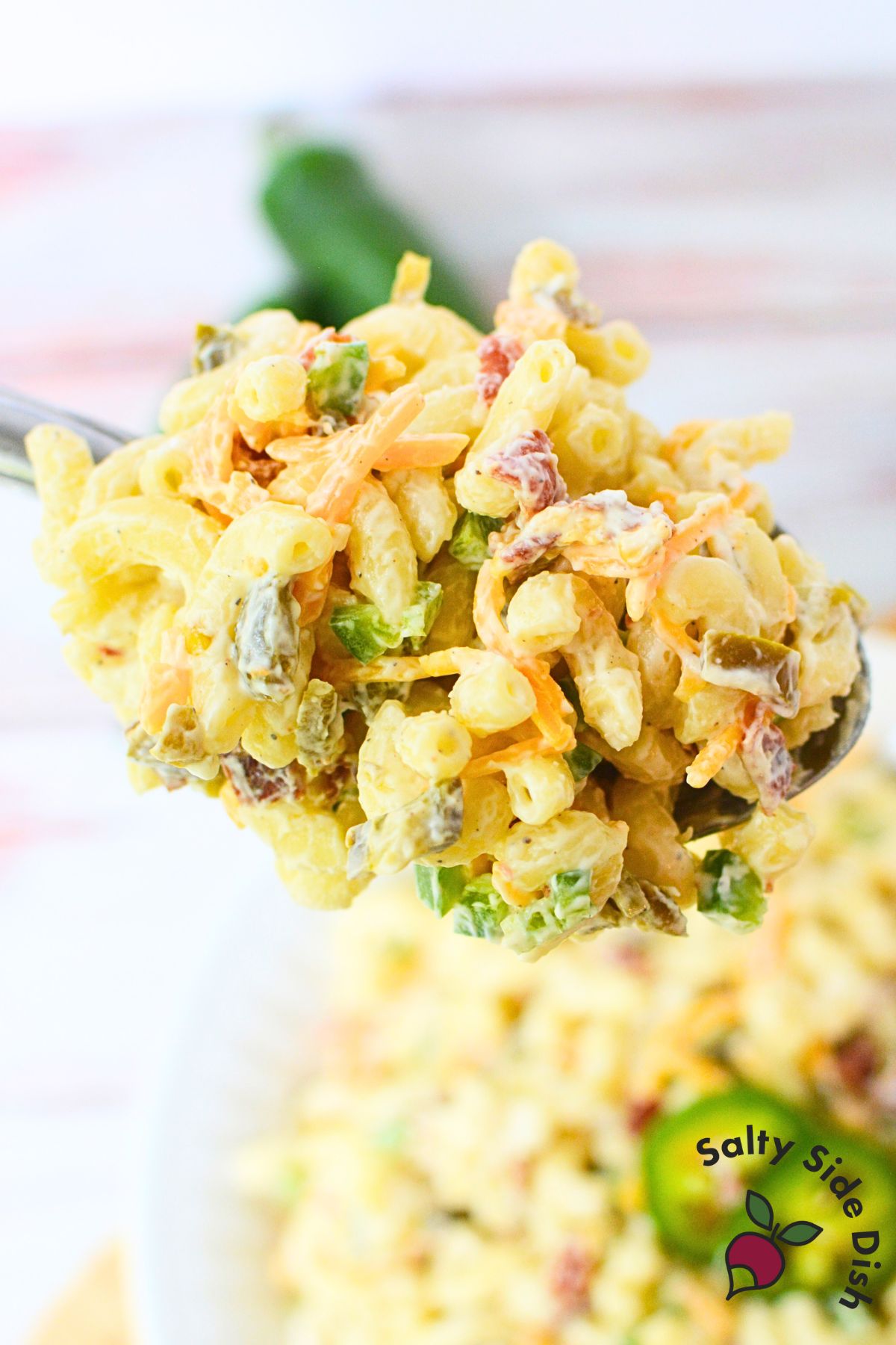 Spoonful of jalapeno popper pasta salad with bacon, cheddar cheese, and jalapenos