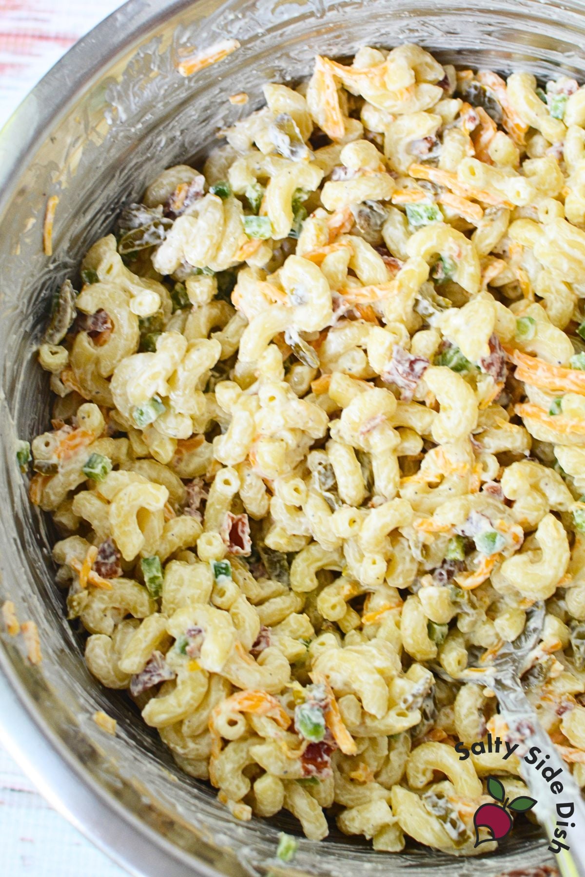 Close view of jalapeno popper pasta salad with creamy dressing, cheddar, and bacon