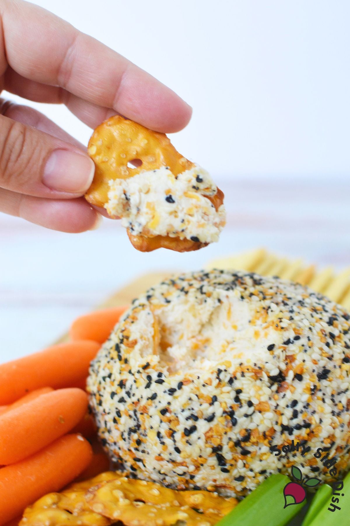 Pretzel crisp scooping creamy everything bagel cheese ball appetizer