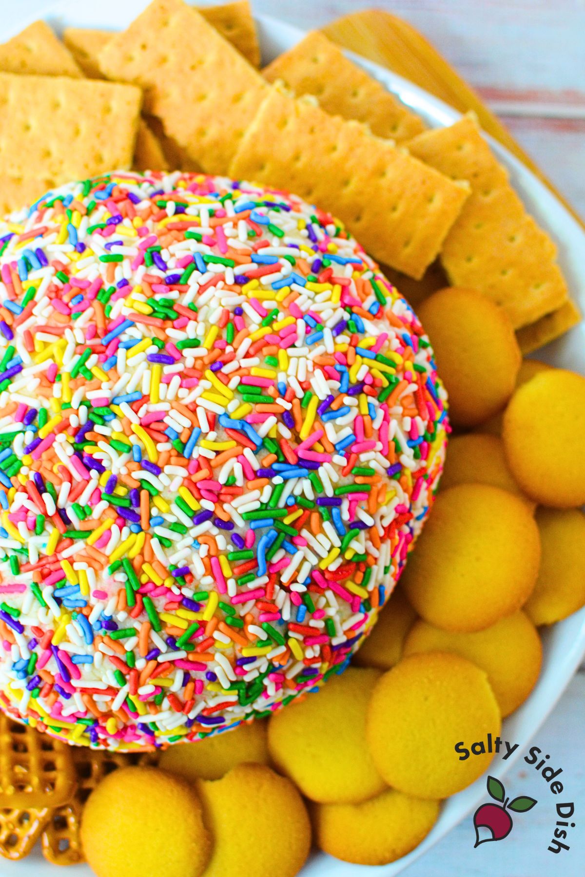 Sweet birthday cake dessert ball made with cream cheese, butter, cake mix, and rainbow sprinkles.