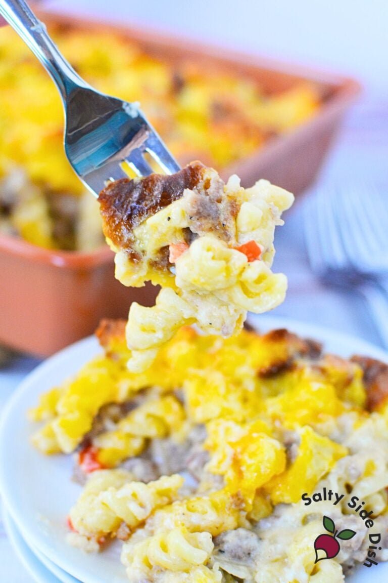 forkful of sausage pasta bake with pasta, sausage, cheese, and biscuit topping