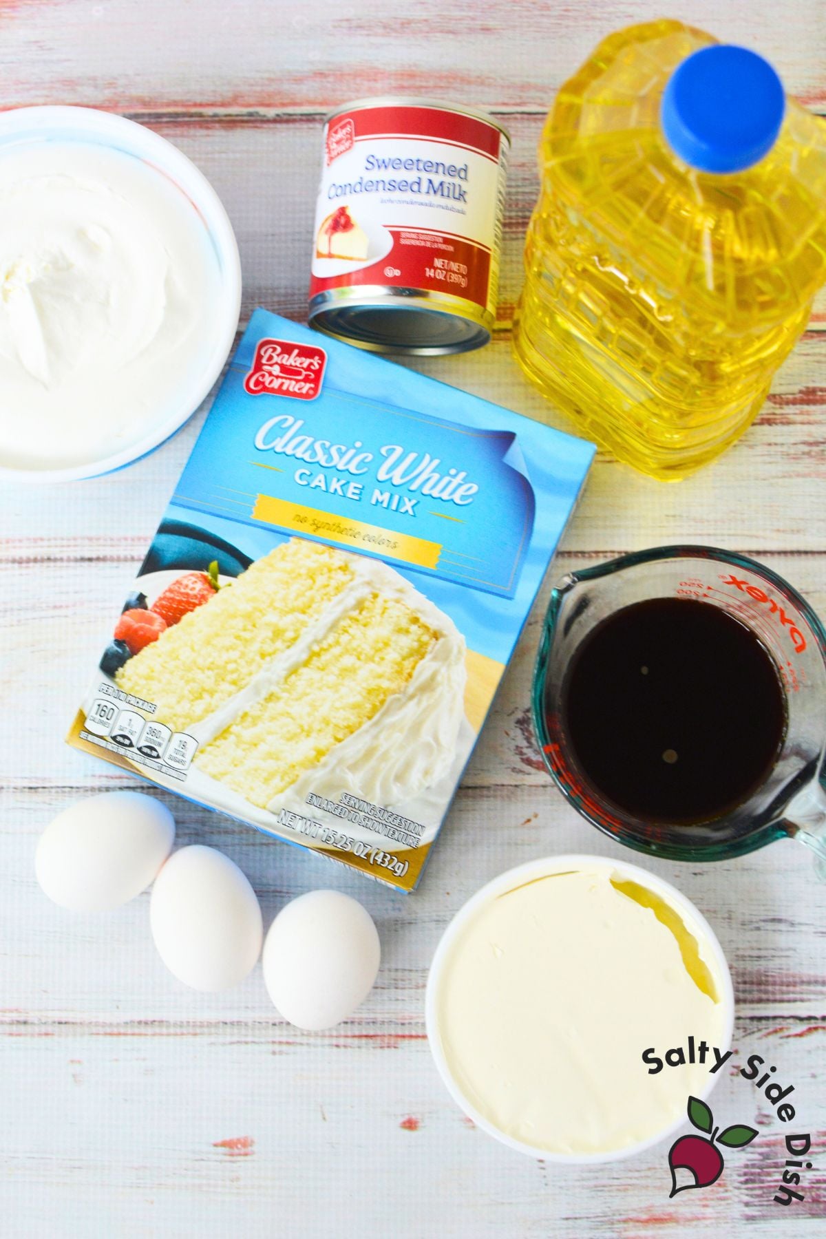 Ingredients for tiramisu poke cake including white cake mix, sweetened condensed milk, mascarpone cheese, eggs, coffee, vegetable oil, and whipped topping.