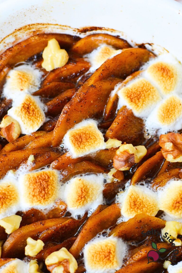 Closeup of scalloped sweet potatoes baked with marshmallows and brown sugar