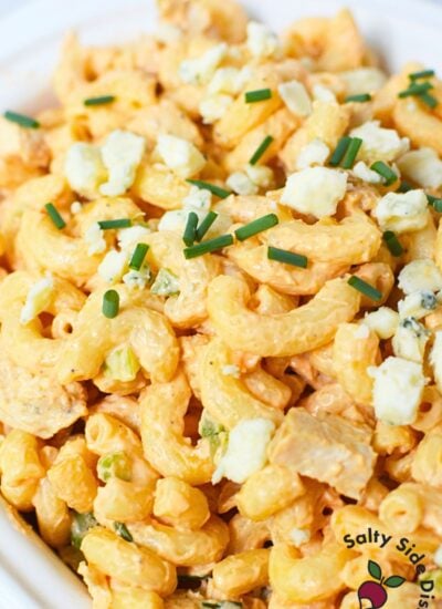 Overhead view of buffalo chicken pasta salad with chives and blue cheese
