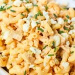 Close-up of creamy buffalo chicken pasta salad with pasta, chicken, and blue cheese