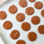 Chocolate dipped Ritz cracker placed on wax paper baking sheet