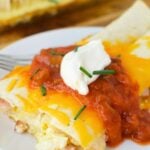 Baked ham and cheese tortillas topped with salsa, sour cream, and chives for a hearty brunch recipe.