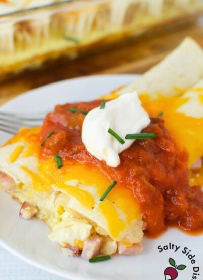 Baked ham and cheese tortillas topped with salsa, sour cream, and chives for a hearty brunch recipe.