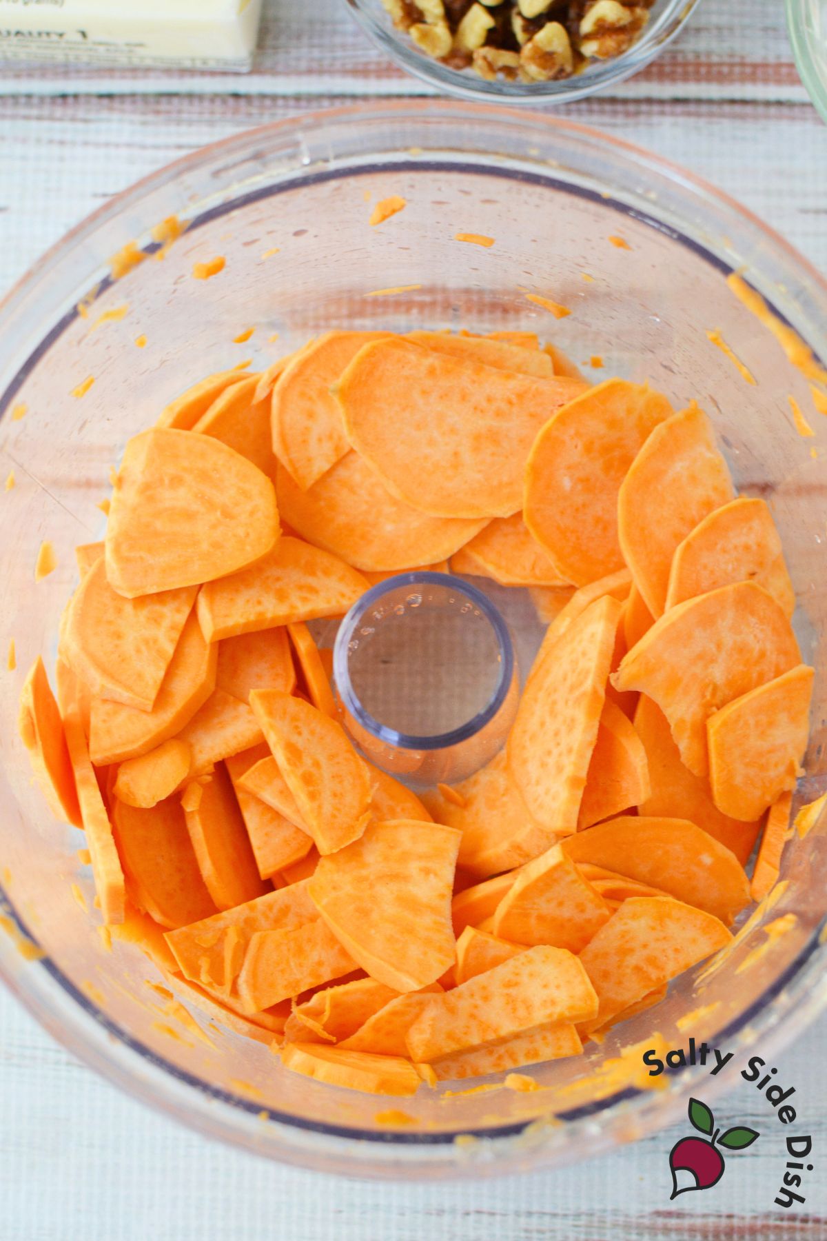 sweet potatoes being prepped in a food processor.