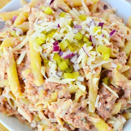 Overhead view of creamy corned beef pasta salad with sauerkraut, cheese, and pasta.