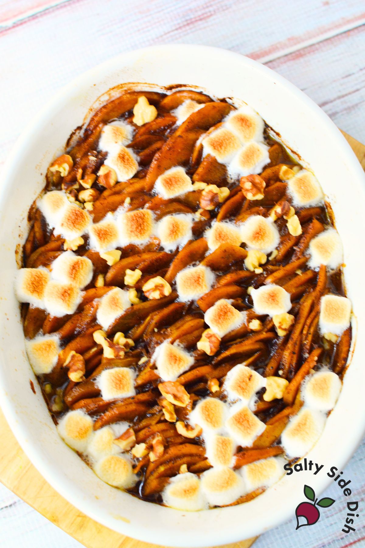 Classic scalloped sweet potatoes topped with golden marshmallows and nuts