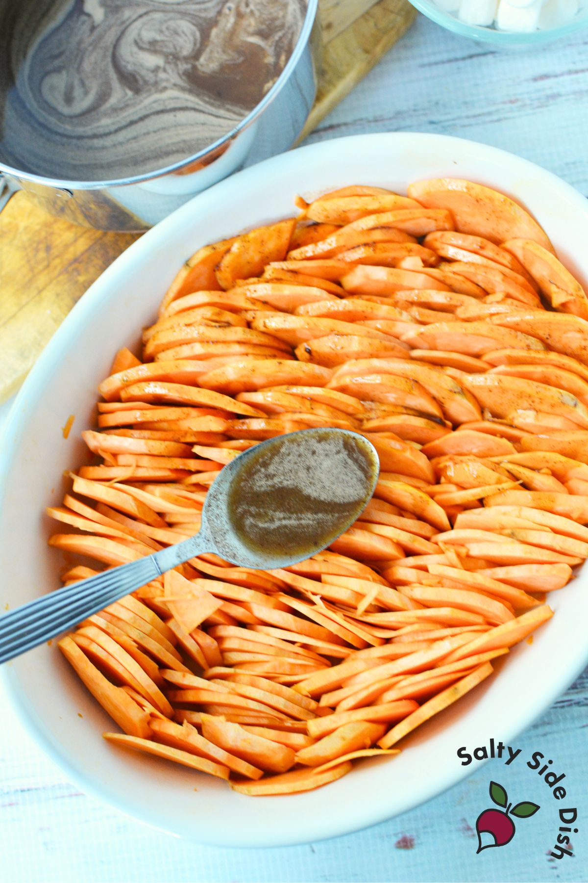 Layered scalloped sweet potatoes with brown sugar butter sauce poured over