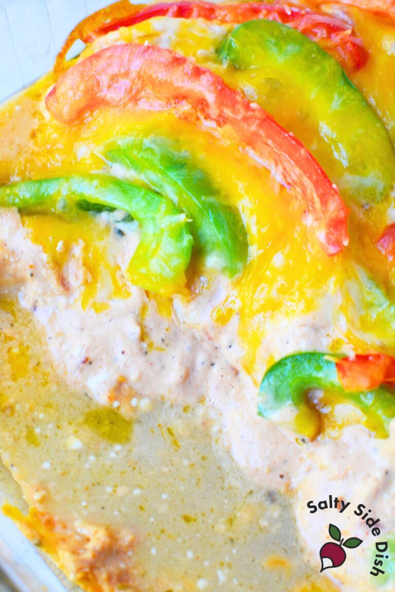 Close up of cheesy chicken fajita casserole with red and green peppers in a creamy sauce