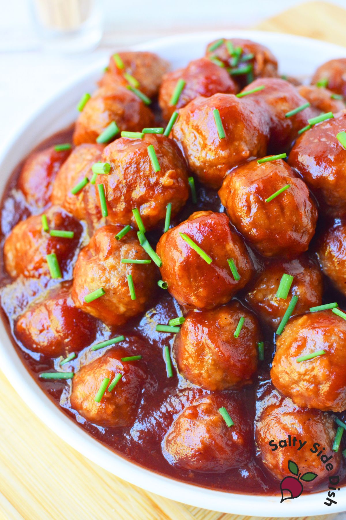 crock pot cranberry chili meatballs piled in a bowl for holiday party