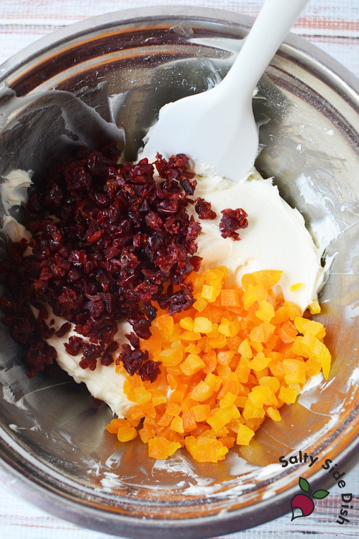 Cream cheese base topped with diced dried apricots and dried cranberries for holiday cranberry orange dip