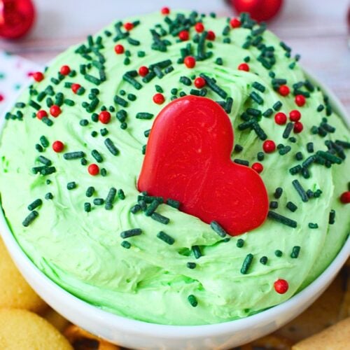 Whoville holiday dip topped with a large red candy heart and Christmas sprinkles