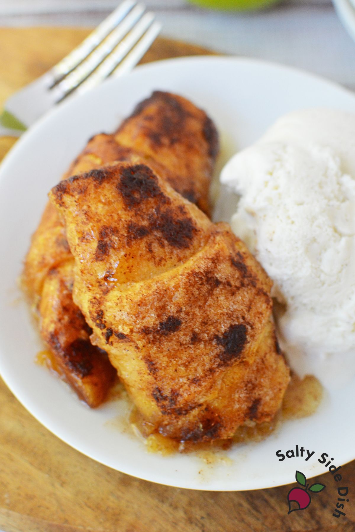 close-up of baked Mountain Dew apple dumplings with ice cream on the side