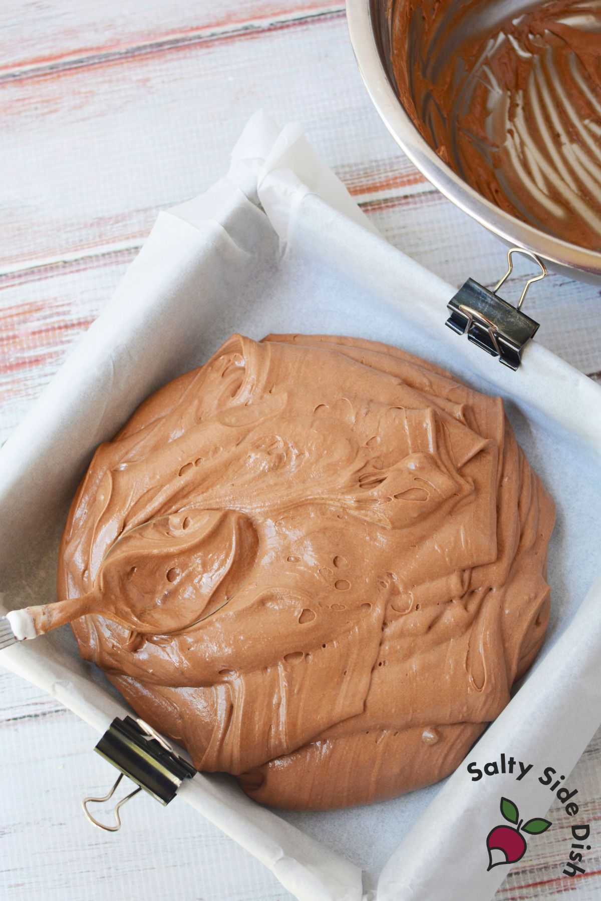 chocolate nougat layer poured into pan for making 3 Musketeers copycat cool whip candy