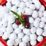 Overhead view of candied sugared cranberries in a festive red bowl for holiday serving.