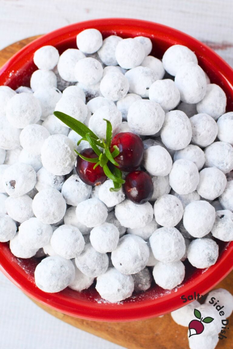 Overhead view of candied sugared cranberries in a festive red bowl for holiday serving.