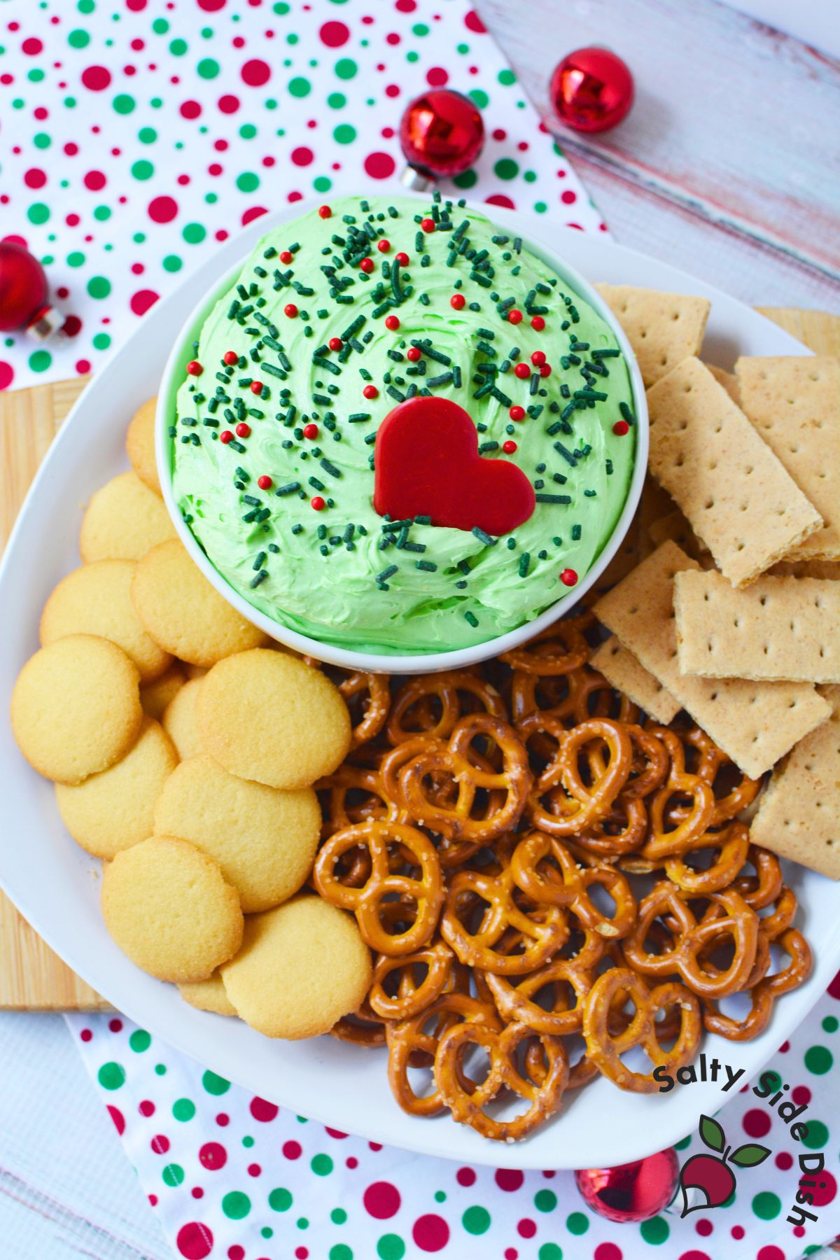 Whoville dip served with pretzels, graham crackers, and cookies on a holiday tray