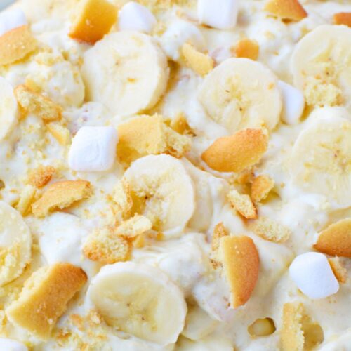 Banana pudding fluff dessert with fresh banana slices and crushed Nilla wafers mixed throughout.