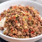 Ground beef and pepper rice bowl served over jasmine rice with colorful diced peppers and onions