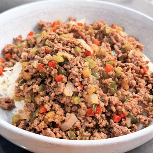 Ground beef and pepper rice bowl served over jasmine rice with colorful diced peppers and onions