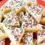 Close up of frosted sugar cookie bars decorated with red, green, and white nonpareil sprinkles