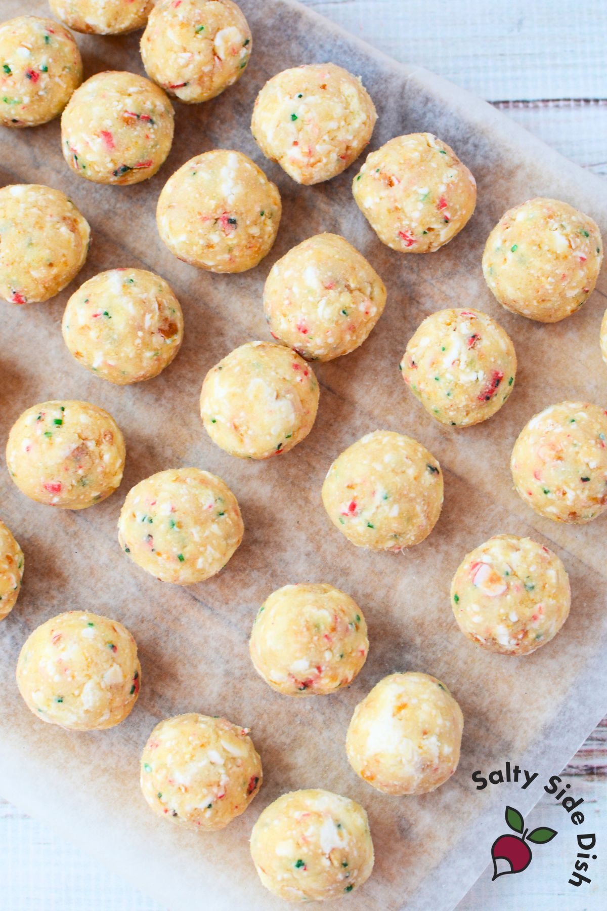 uncoated christmas tree cake truffle balls rolled and ready for dipping on parchment paper