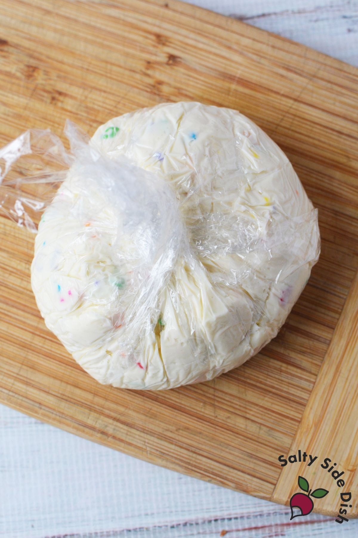 Sweet cheeseball mixture wrapped in plastic wrap and chilled before decorating with 6-7 sprinkles.
