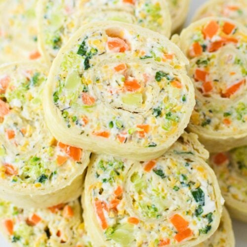 Stack of fresh vegetable pinwheels on a plate, ready to serve as an easy make-ahead appetizer for parties and holidays.