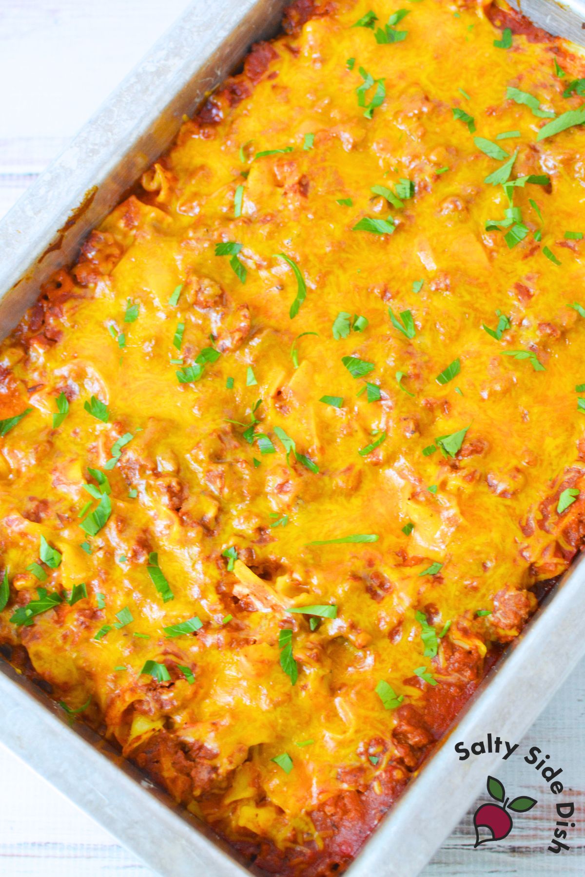 step by step photos showing how to make tomato beef noodle casserole with beef, noodles, and red sauc