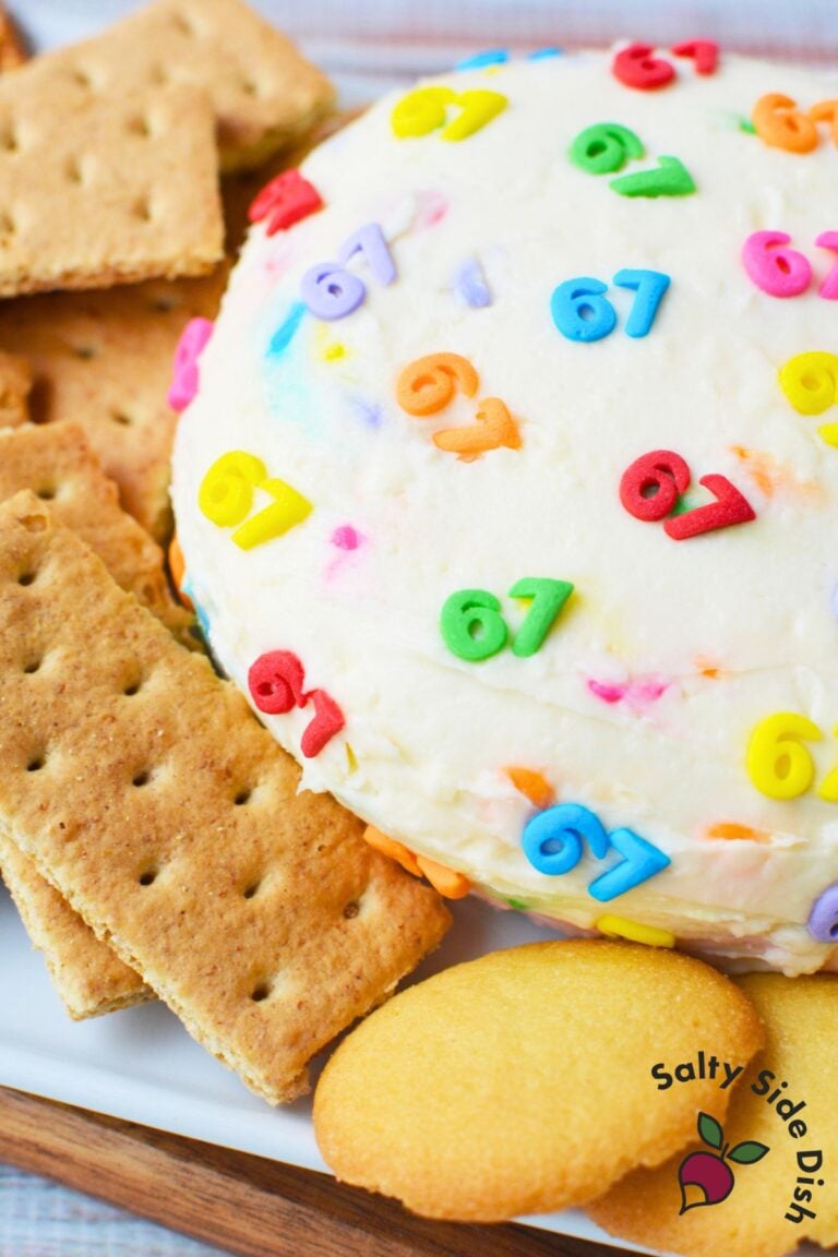 Finished 6-7 cheeseball decorated with colorful number sprinkles, ready to serve for a classroom or kids party.