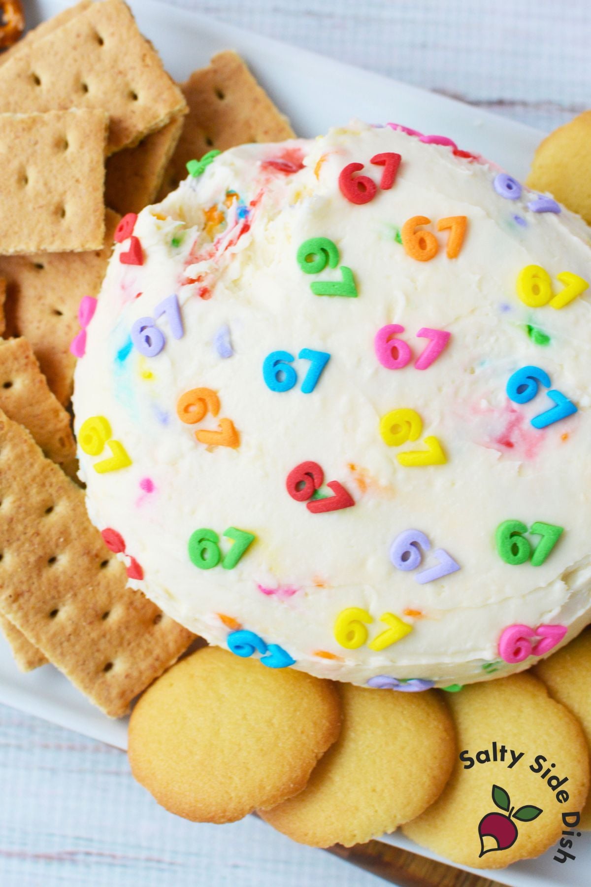 6-7 cheeseball dessert served on a platter with pretzels, graham crackers, and Nilla wafers for easy holiday snacking.