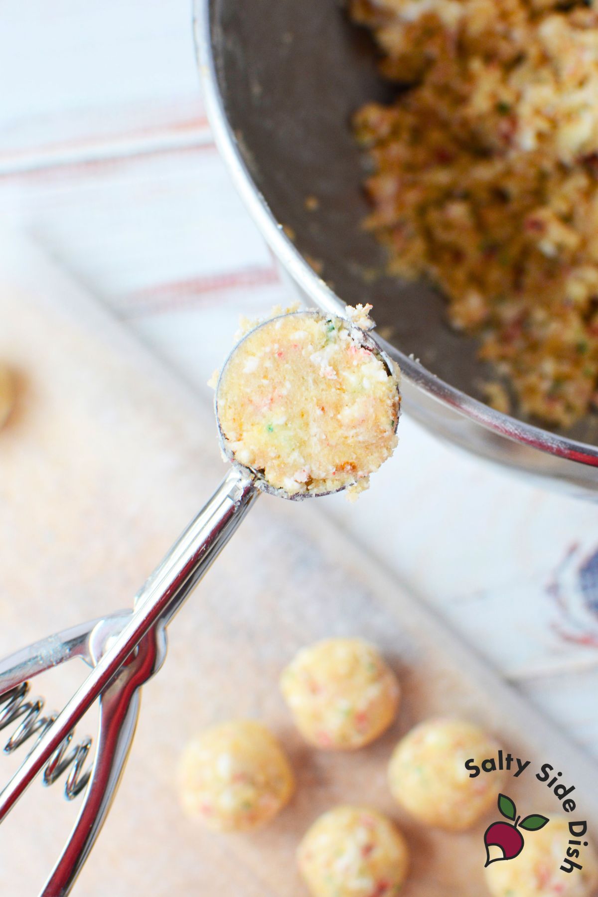 tablespoon cookie scoop portioning christmas tree cake mixture for rolling into cake balls