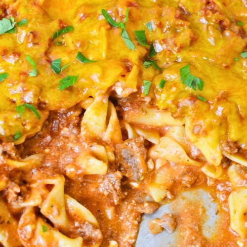 saucy tomato beef noodle casserole showing creamy noodles and ground beef