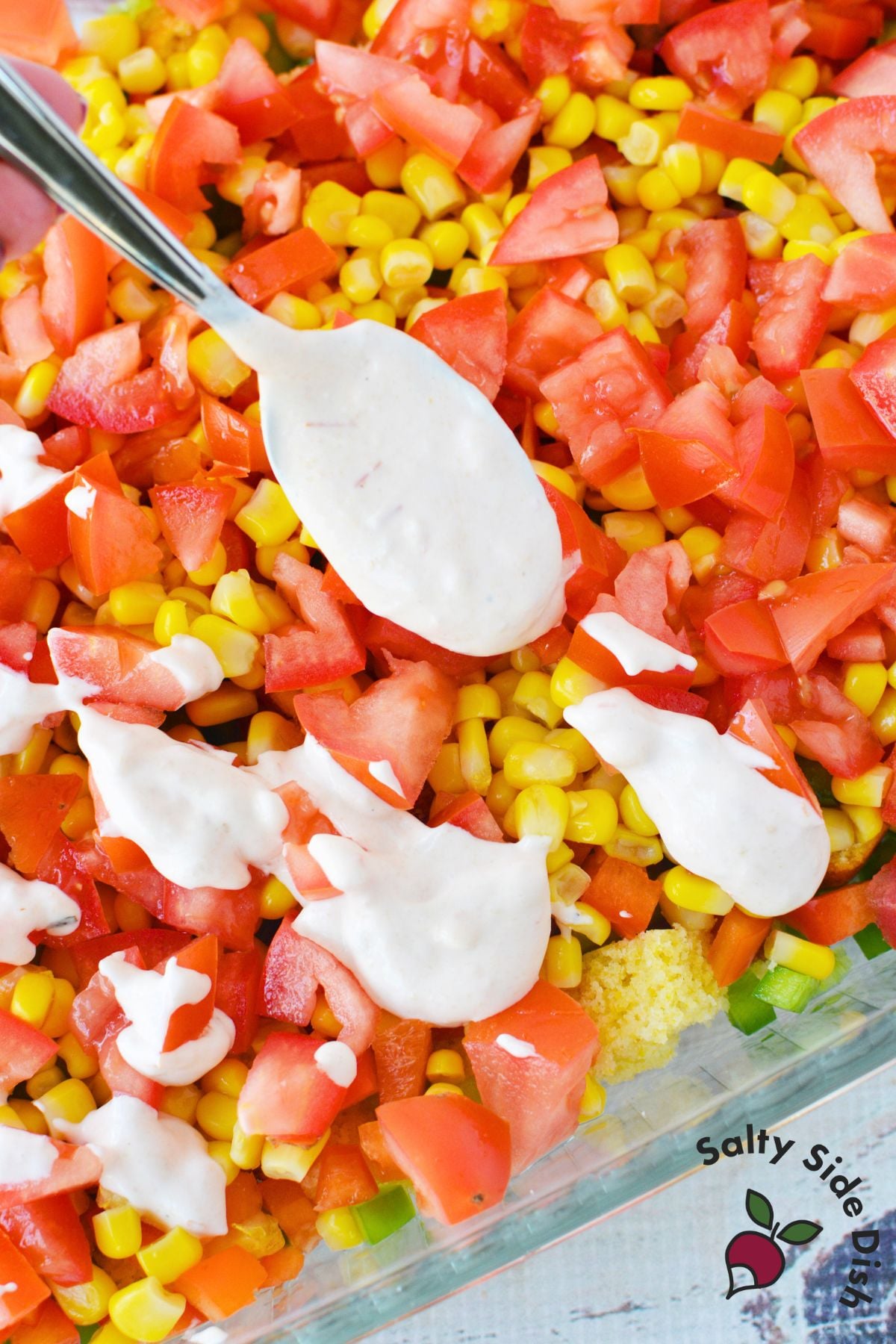 drizzled ranch salsa dressing over layered cornbread salad before adding cheese