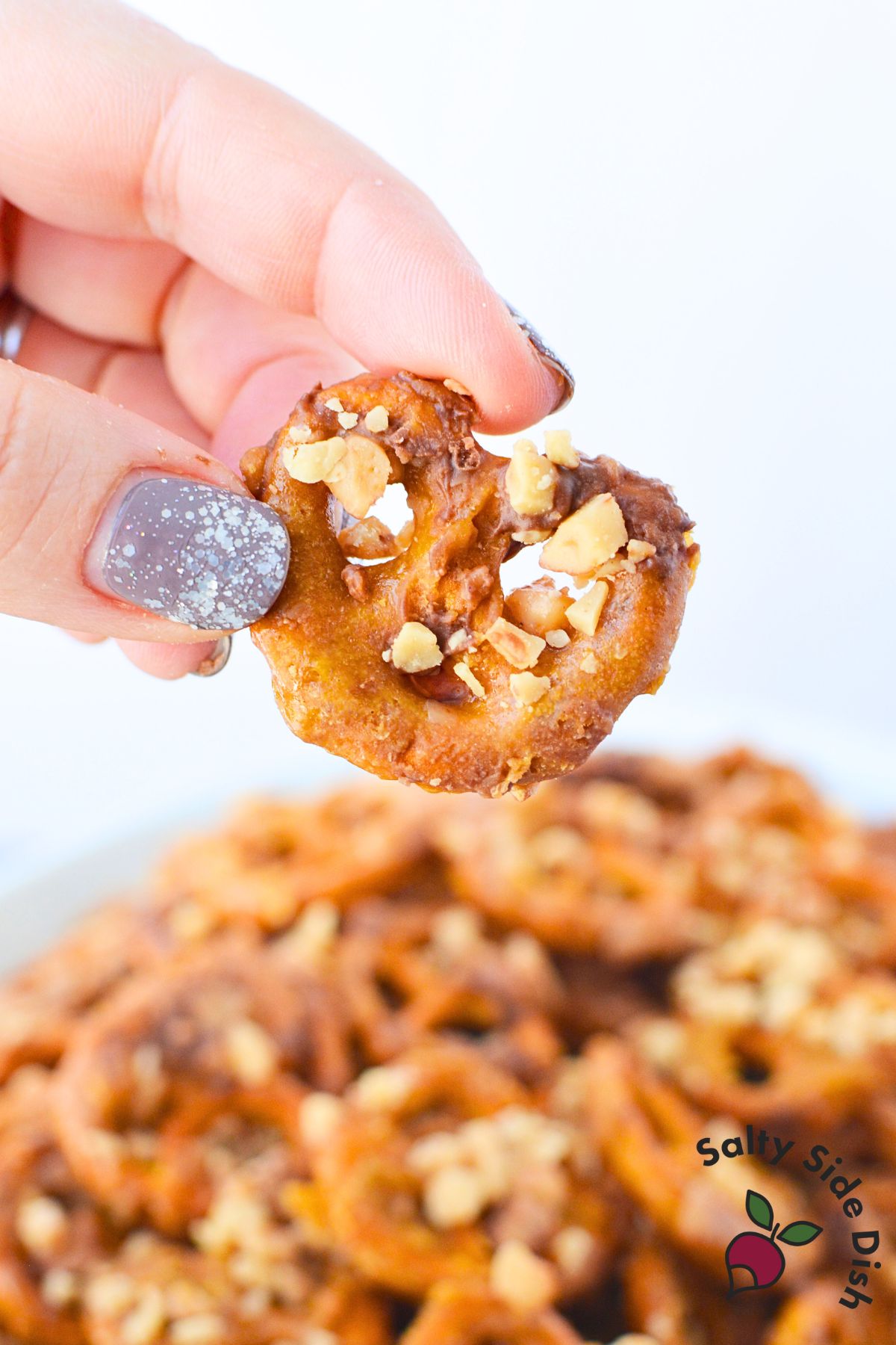 hand holding heath pretzels.