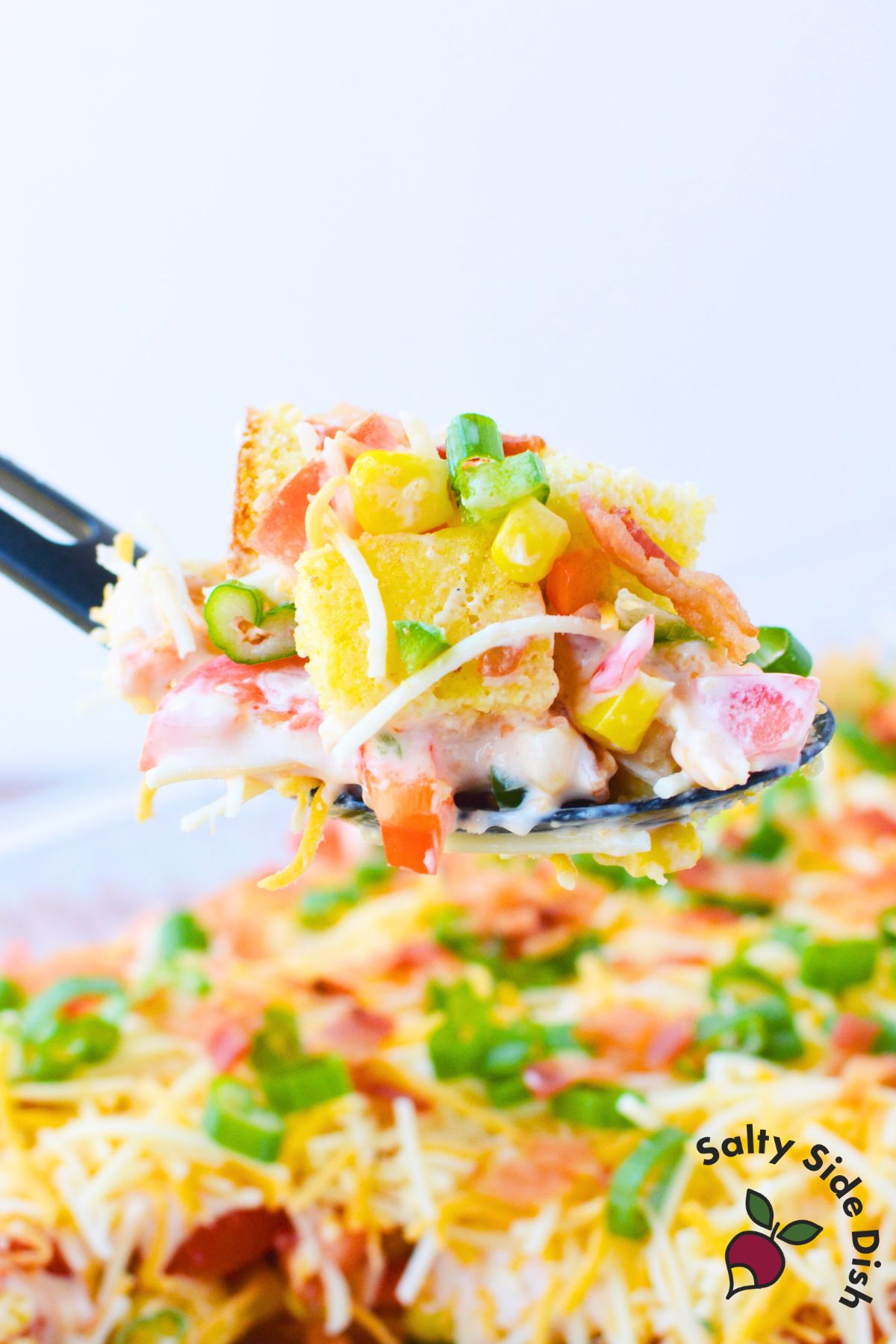 southern cornbread salad with sweet cornbread corn peppers bacon and ranch dressing in a baking dish