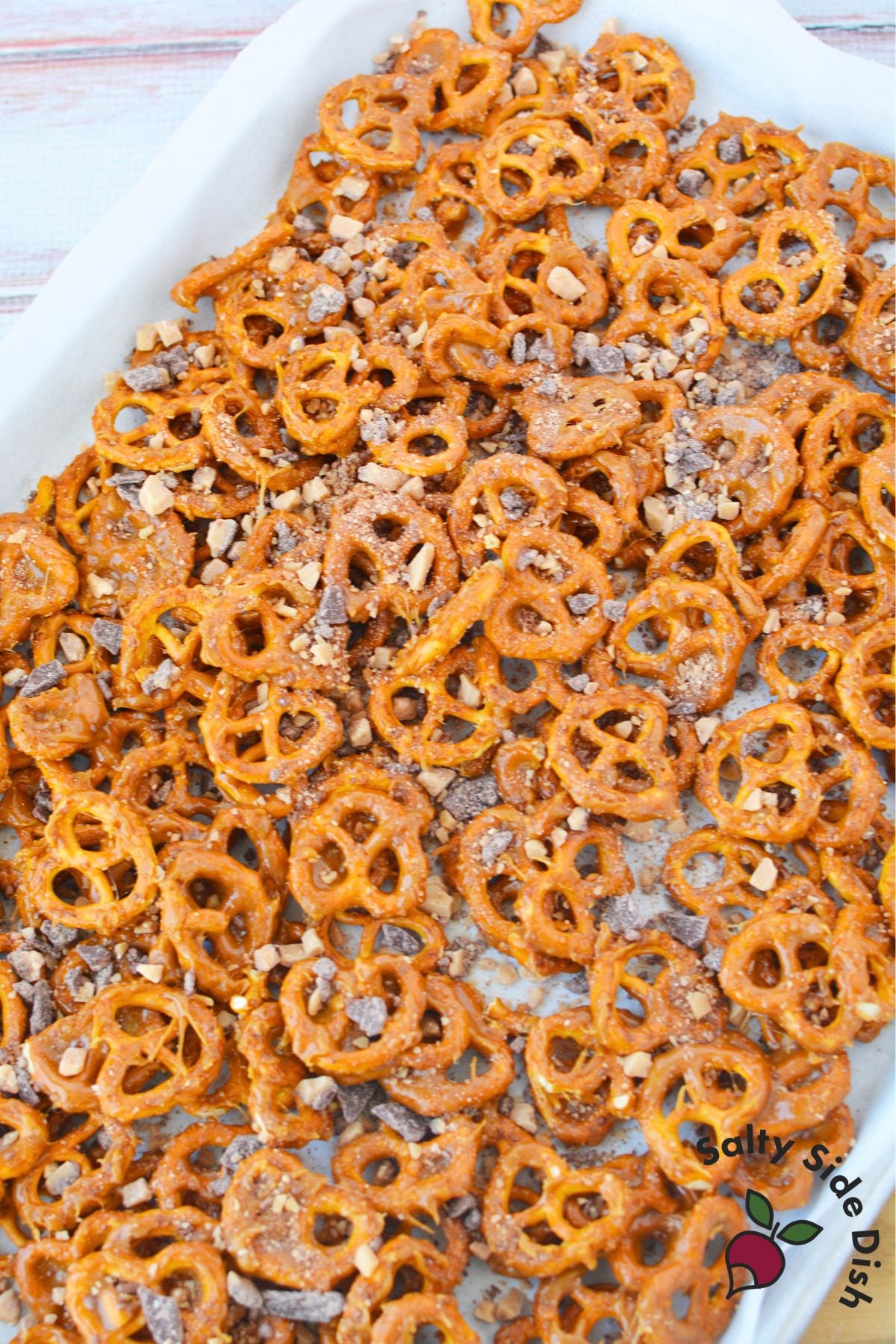 sweet and salty butter toffee pretzels cooling on a parchment lined baking sheet