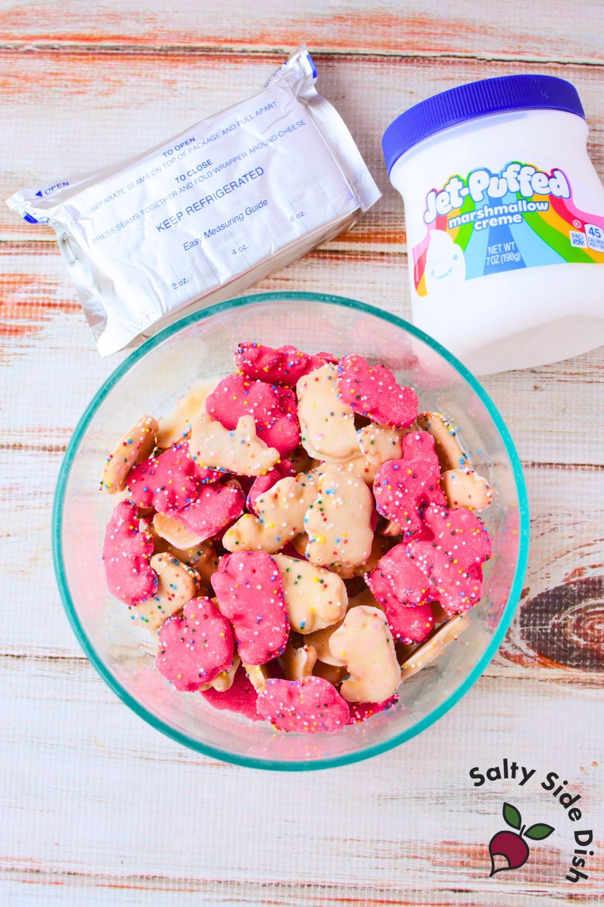 Ingredients for frosted animal cracker dip including cream cheese marshmallow cream and circus animal cookies