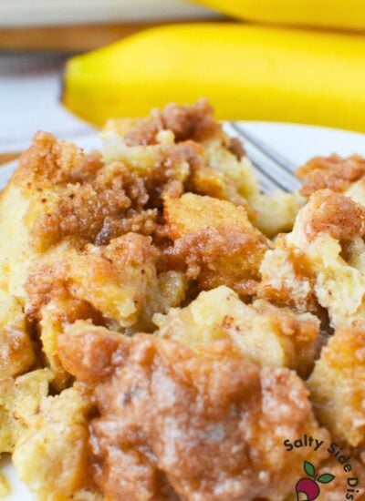 Close up of banana French toast bake with a cinnamon brown sugar crumb topping and soft custard texture