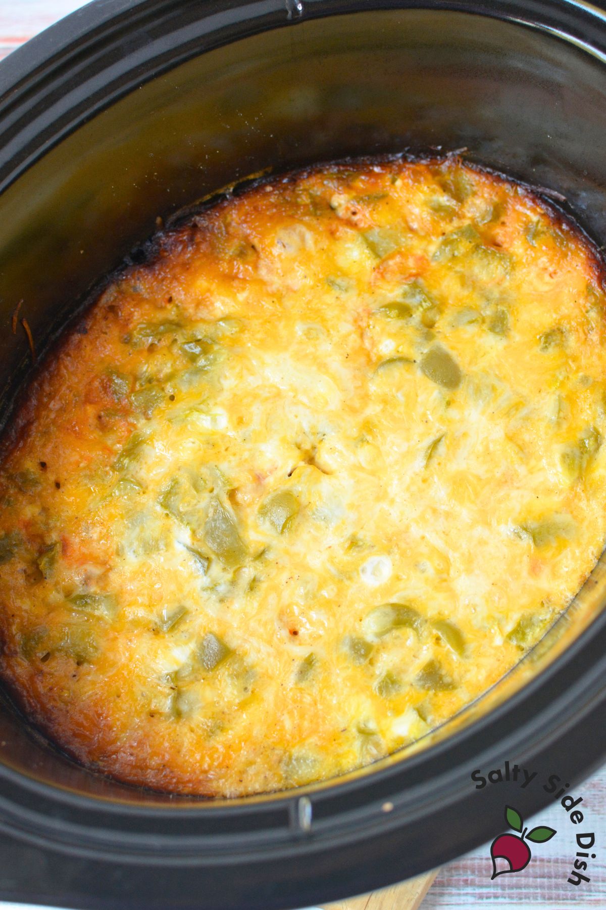 Crockpot eggs with sausage, salsa, and cheese cooked together for breakfast burritos and tacos