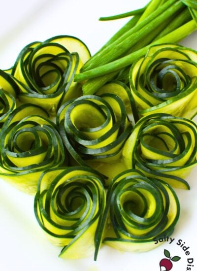 Cucumber roses arranged on a plate as a decorative garnish for charcuterie boards