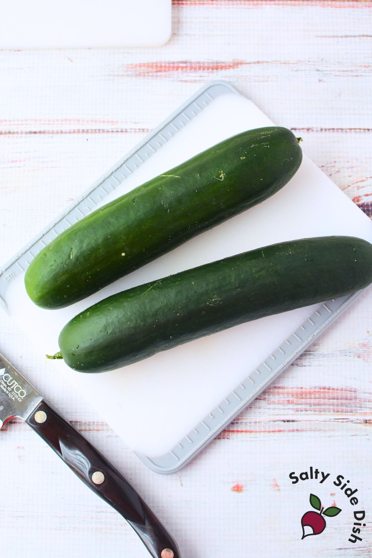 Whole cucumbers on a cutting board ready for slicing into cucumber roses